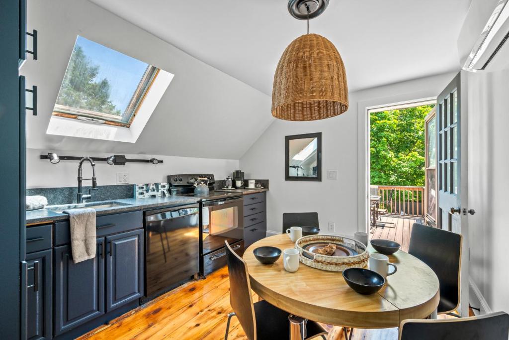 a kitchen with a wooden table and a dining room at Broadway in Rockport