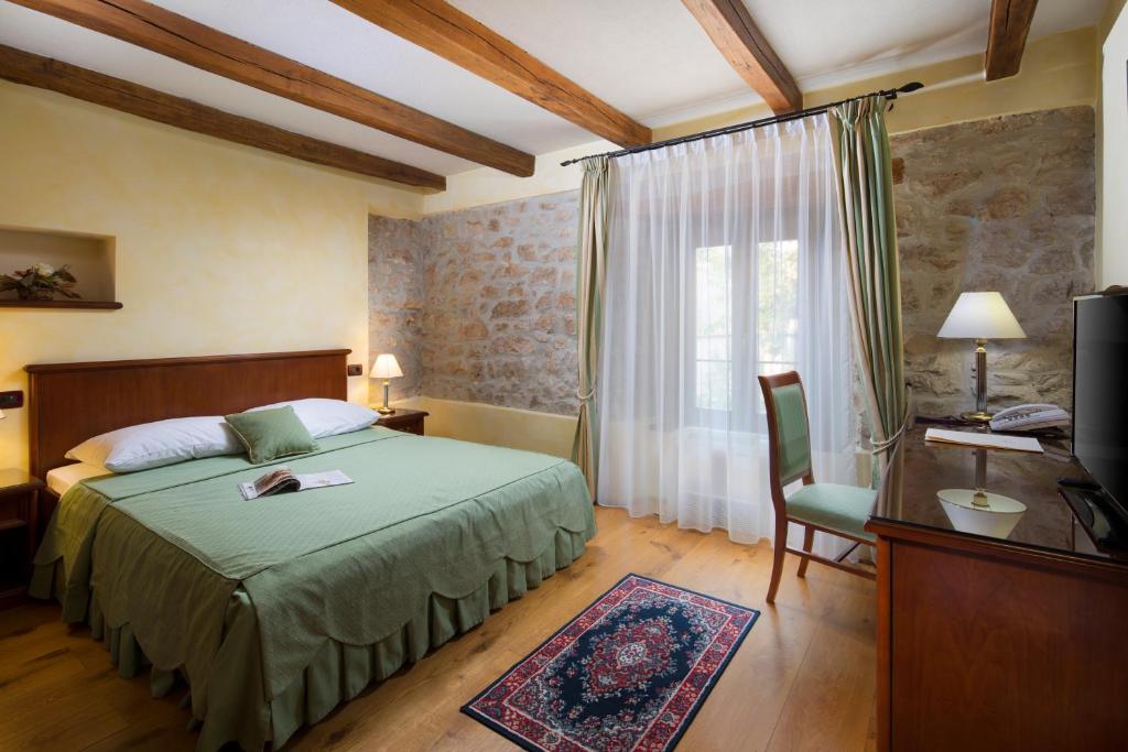 En eller flere senger på et rom på Heritage Hotel San Rocco