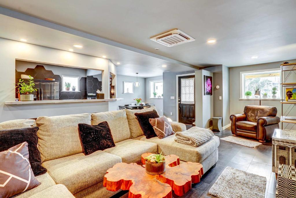 a living room with a couch and a chair at 'Little House on the Lot' Dryden Townhome: Pets OK in Dryden