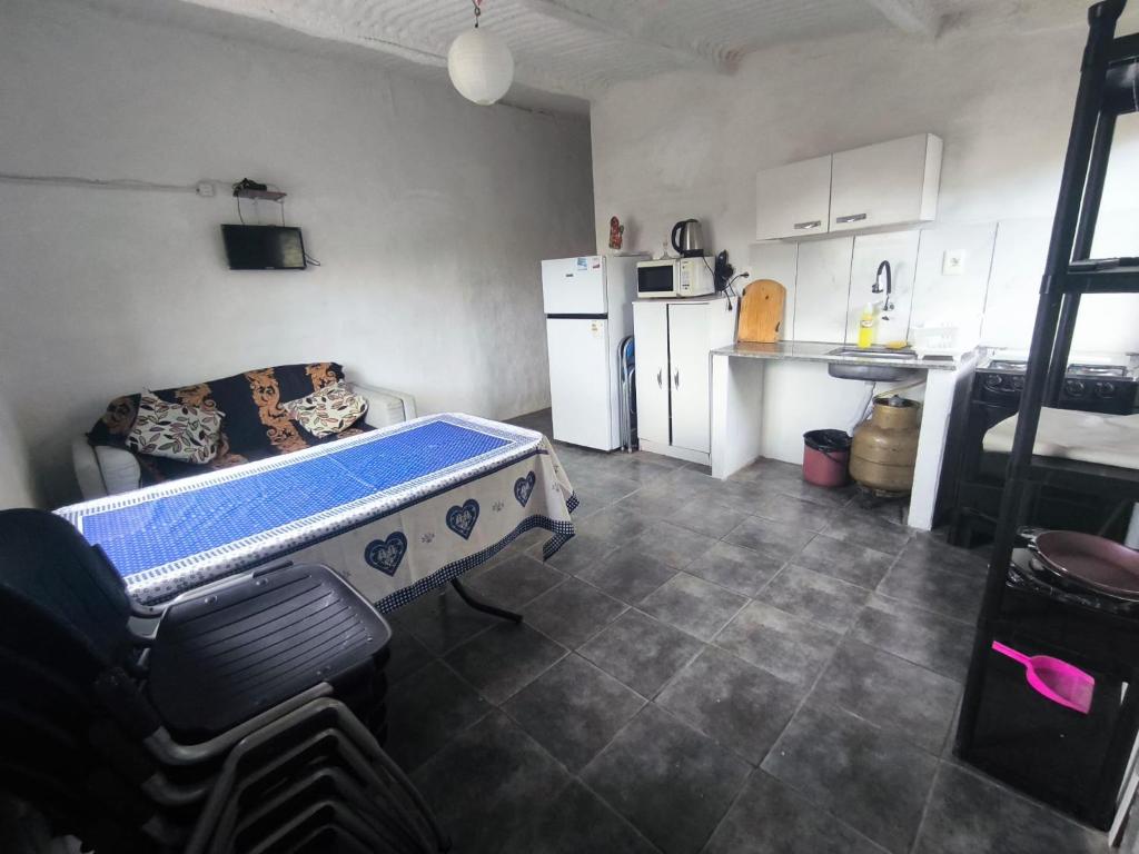 a kitchen with a table in the middle of a room at La casa de Juan in Cuchilla Alta