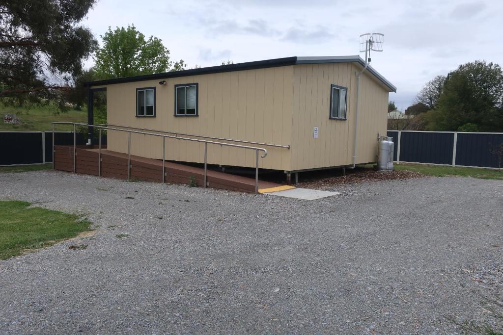 a small building with a ramp in a parking lot at Delegate Galley Cabin in Delegate