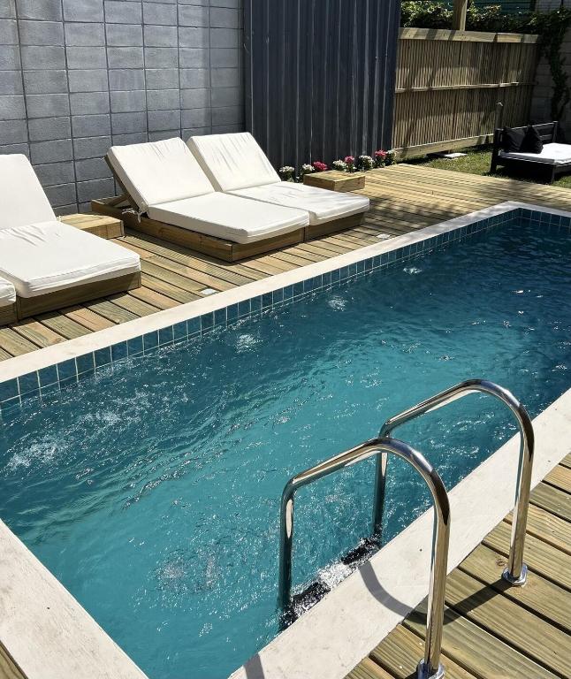 a swimming pool with a bed in the middle of it at Pedre Loft in La Pedrera