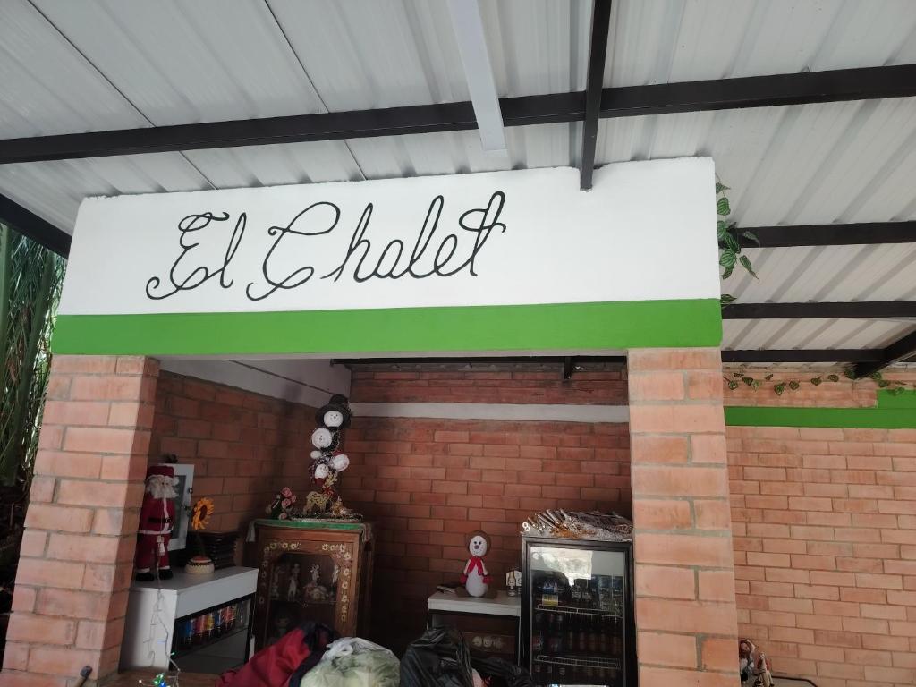 a sign that reads el chhalili above a brick wall at Salon de eventos cabaña el Chalet in Paipa