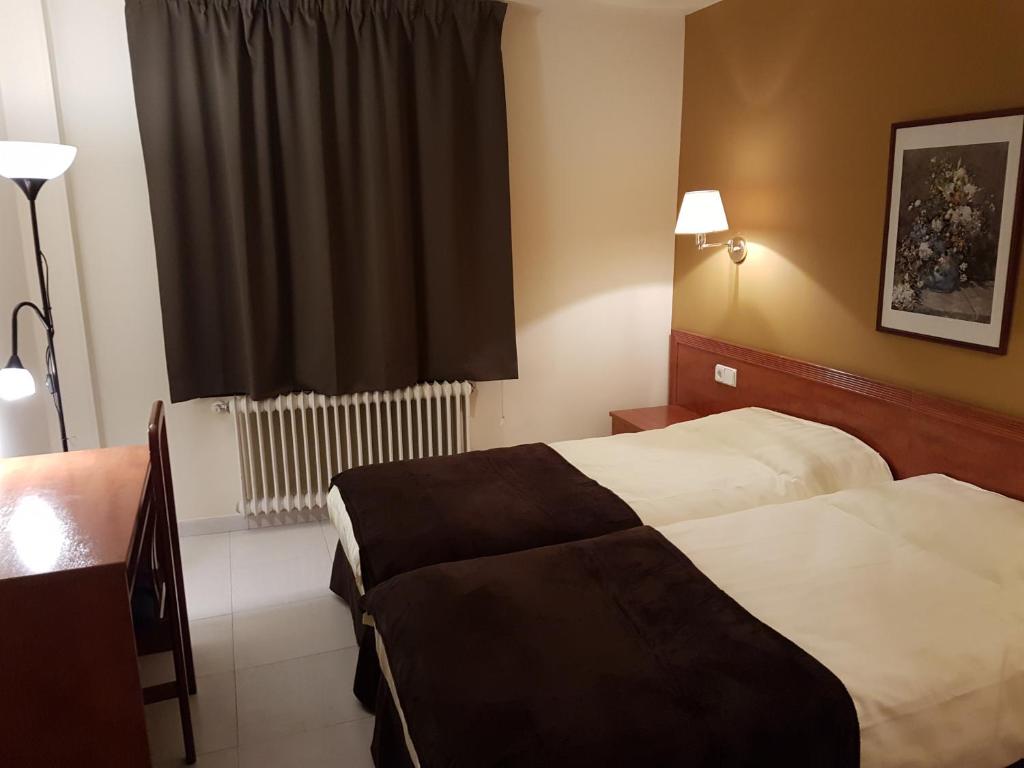 Postel nebo postele na pokoji v ubytování Hotel Guineu
