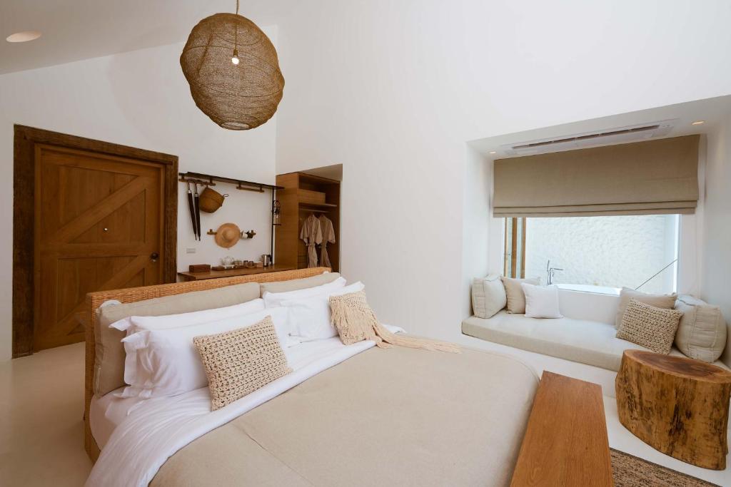 北冲Roukh Kiri Khaoyai, The Centara Collection的带一张大床和一张沙发的卧室