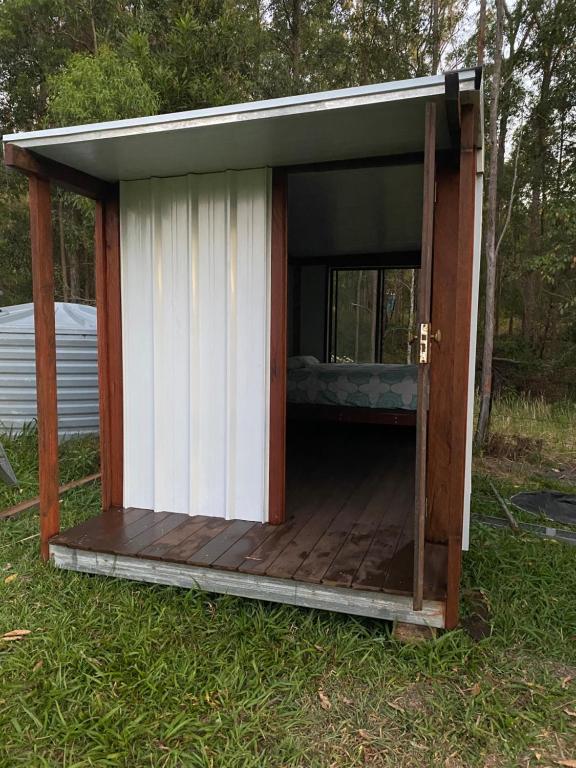 a shed with a porch and a bed in it at Soulhaven at Bentley in Bentley