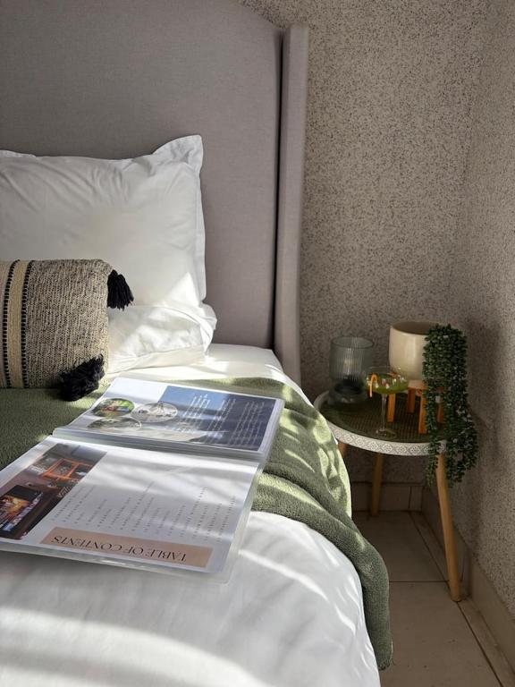 a book on a bed with a magazine on it at Shayas Haven in Thohoyandou