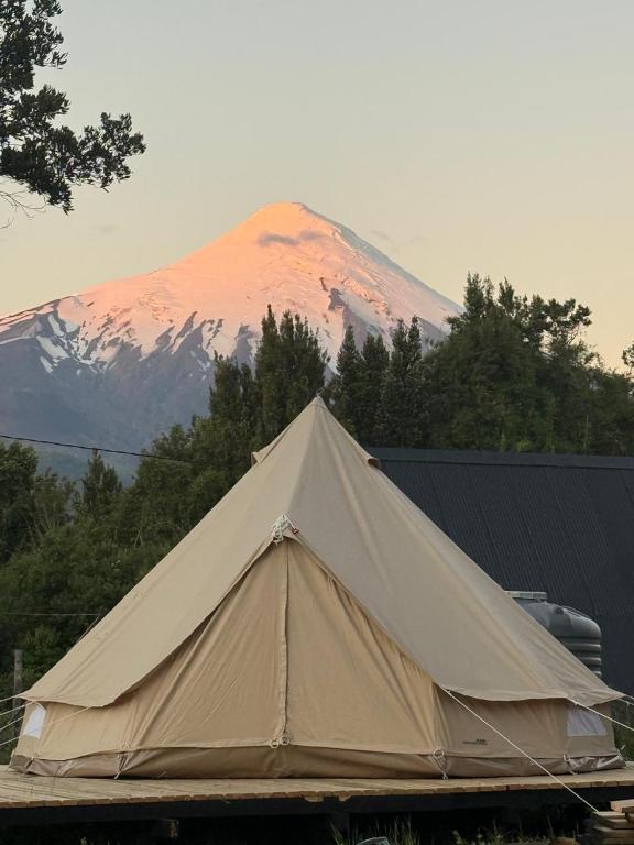 a large tan tent in front of a mountain at Glamping Peumayen Chucao in Llanquihue