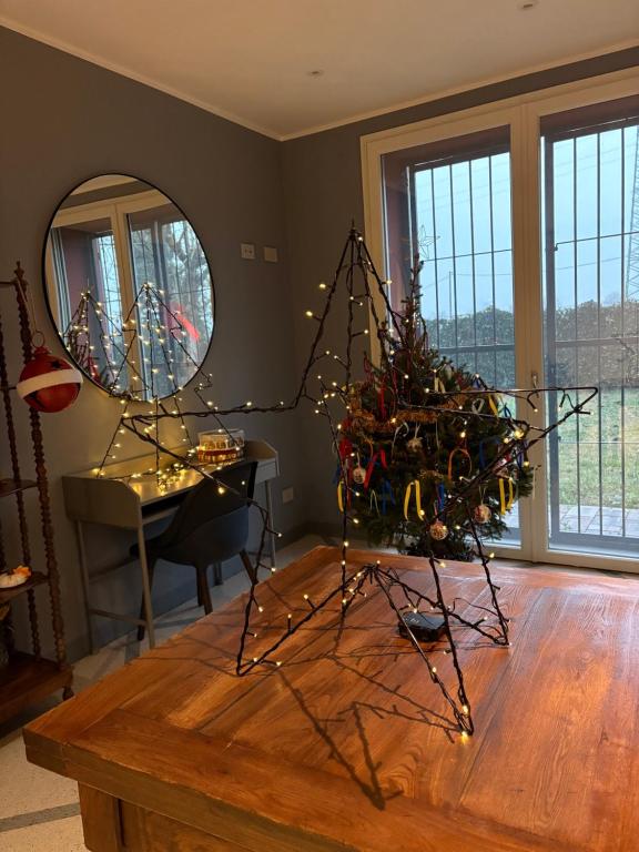 ein Wohnzimmer mit einem Tisch und einem Spiegel in der Unterkunft Sala dell Estate Guest House in Secchia