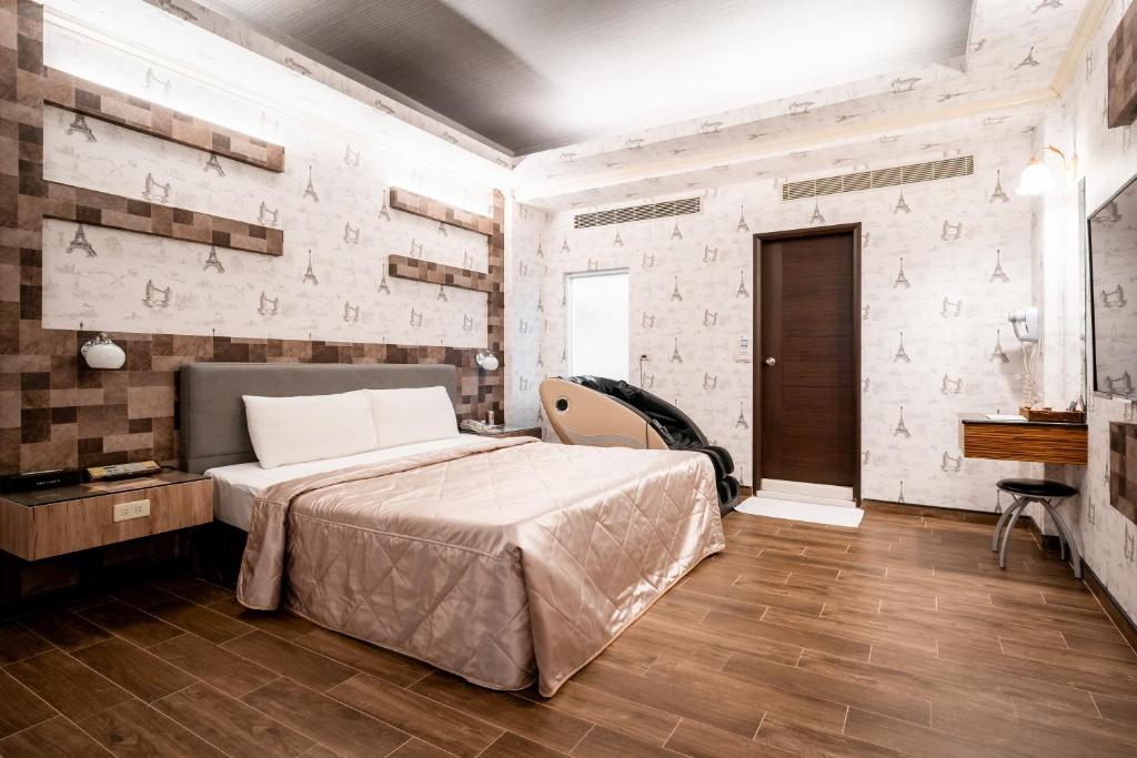 En eller flere senge i et værelse på Holland Village Motel