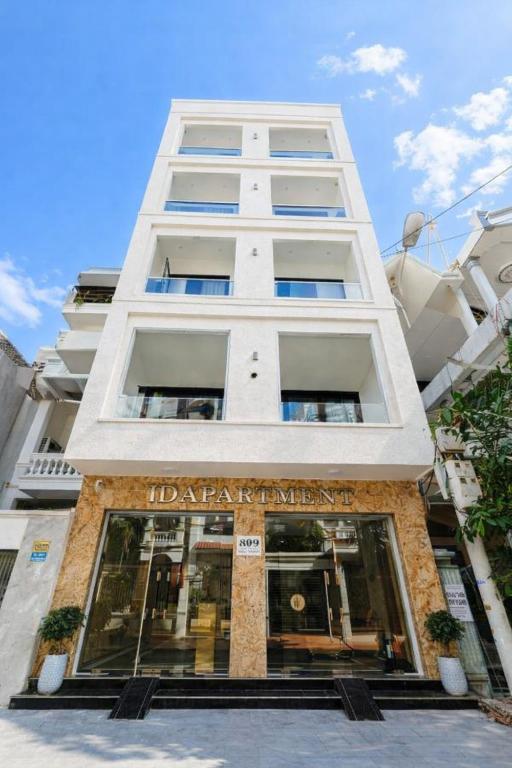 a tall white building with a store at TD Apartment in Hai Phong