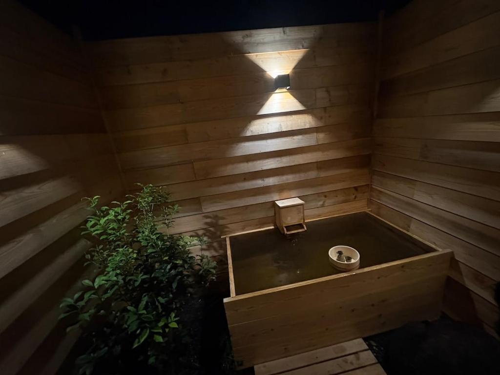 a sauna with a sink and a plant at 最大10名 源泉掛け流し露天風呂付き一棟貸しNagasima Private Villa in Genroku