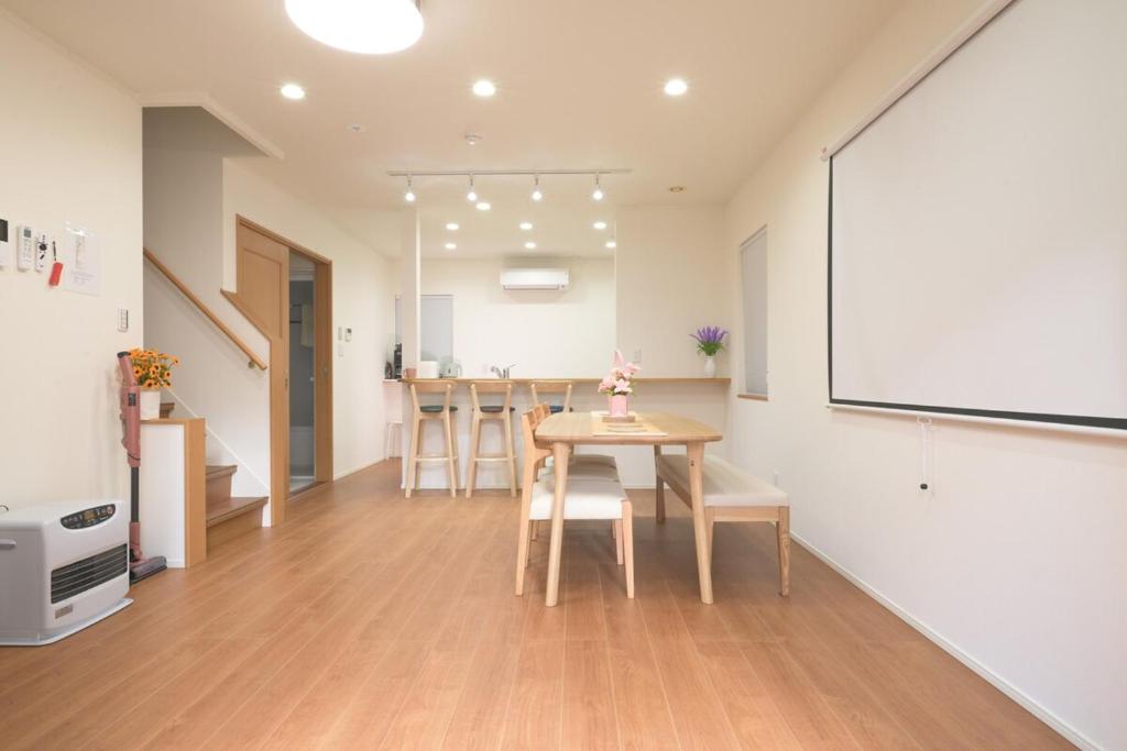 a kitchen and dining room with a table and chairs at Peace and Harmony House Rongsheng in Nagoya