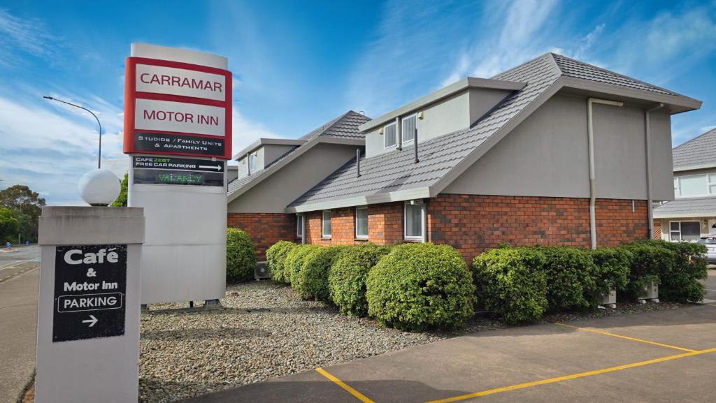 una casa con un cartello davanti di Carramar Motor Inn a Palmerston North
