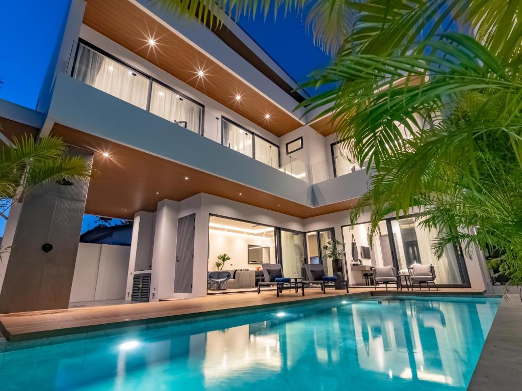 an exterior view of a house with a swimming pool at Dara Villas - Rawai in Rawai Beach