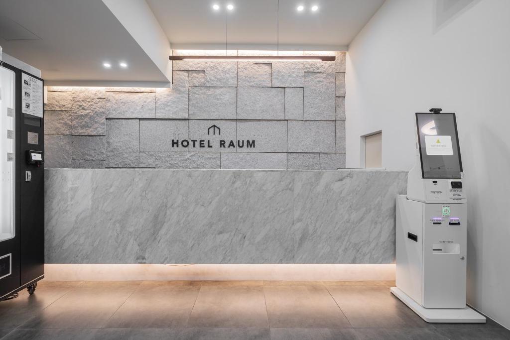 a lobby with a hotel roma sign on a wall at Jamsil Raum Tourist Hotel in Seoul