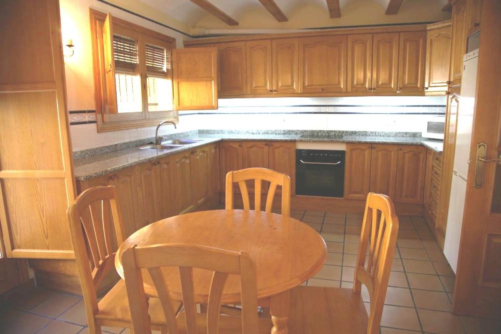 a kitchen with a table and chairs and a sink at Casa Puritat in Morella