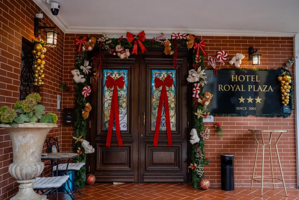 an entrance to a hotel royal plaza with christmas decorations at Hotel Royal Plaza By TimHotels in Timişoara