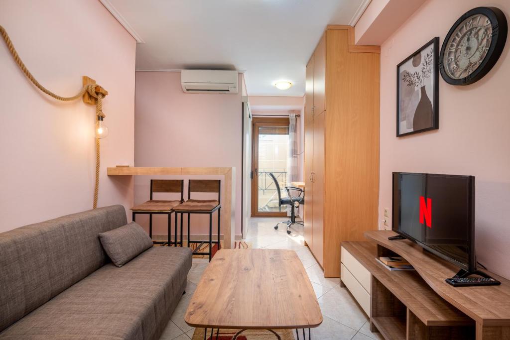 a living room with a couch and a tv at Mytilene Central Home 2 in Mytilini