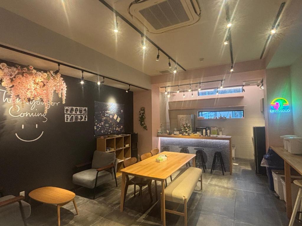 a dining room with a table and chairs at Hostel Hangout Best Value Near Kuromon Market & Namba in Osaka