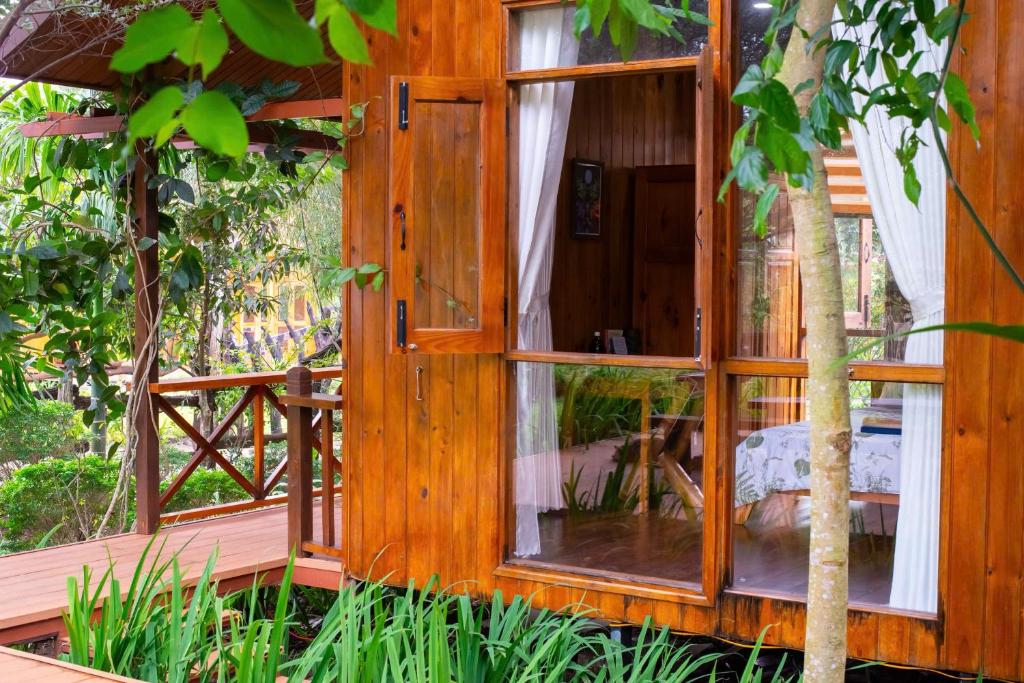 a wooden house with a window on a deck at DuGiang Homestay in Buon Ma Thuot