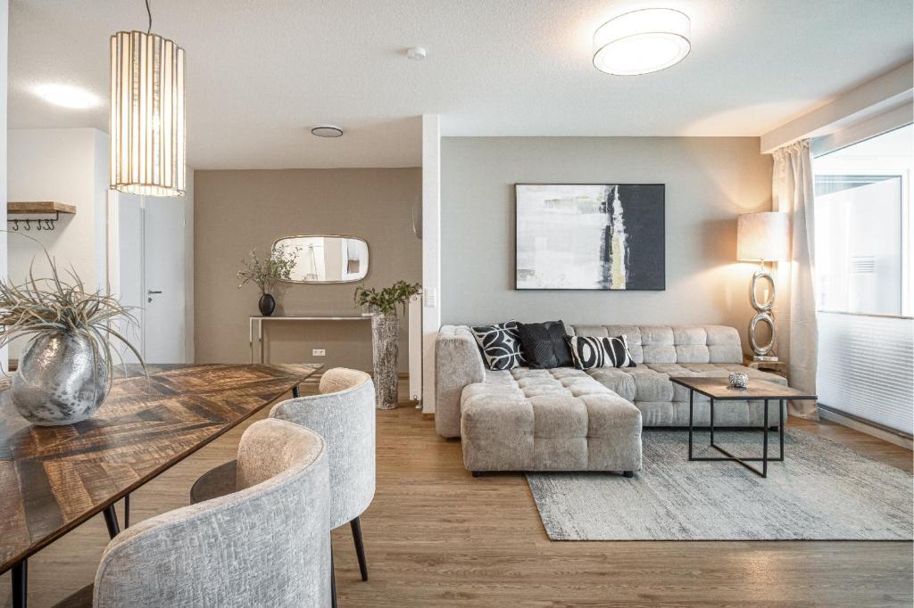 a living room with a table and a couch at Ostseebrise Olpenitz in Olpenitz