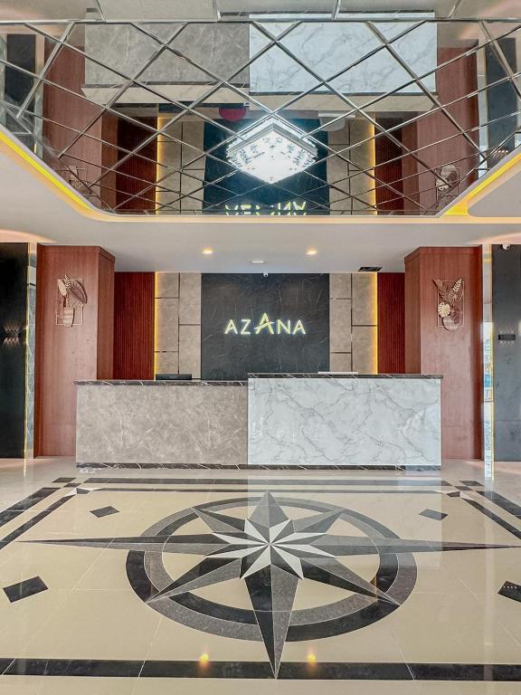 a lobby with aania sign on the floor of a building at Azana Style Hotel Jombang in Peterongan