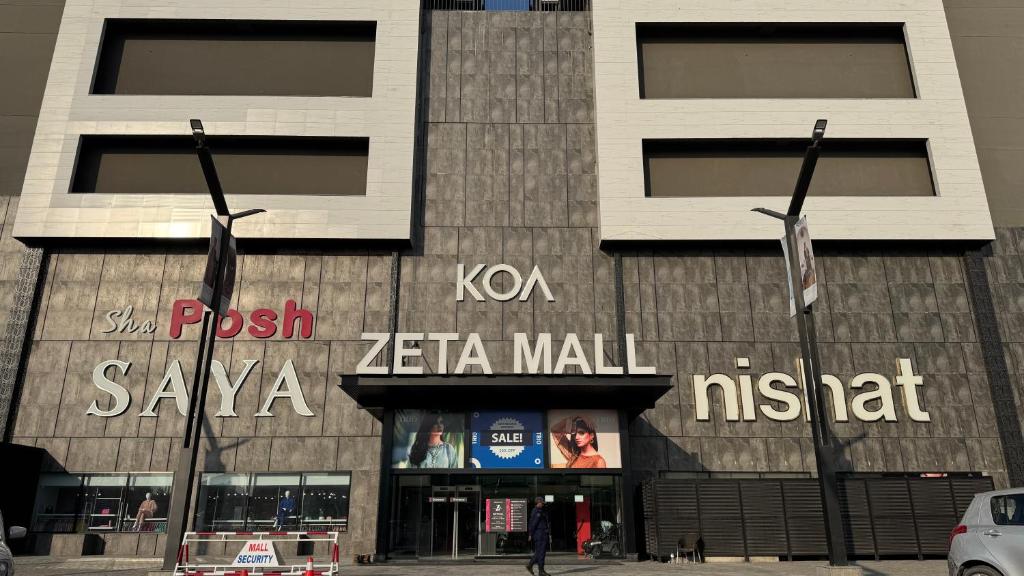een gebouw met twee vlaggen ervoor bij Executive 2BHK in Zeta Mall in Islamabad