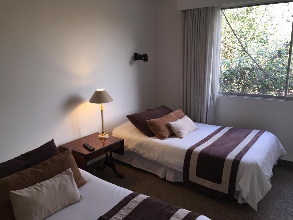 Postel nebo postele na pokoji v ubytování Hotel Acacias de Vitacura