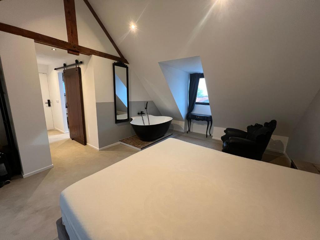 En eller flere senge i et værelse på Hotel Aardenburg