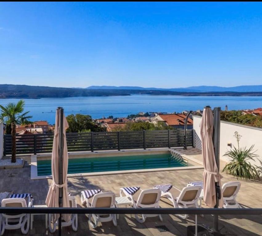 een balkon met stoelen en uitzicht op het water bij Panorama Residence in Crikvenica