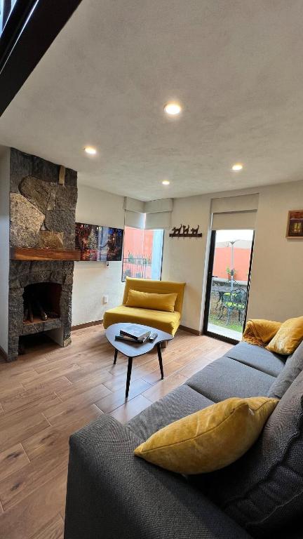 a living room with a couch and a chair at Casa Margarita in Pátzcuaro