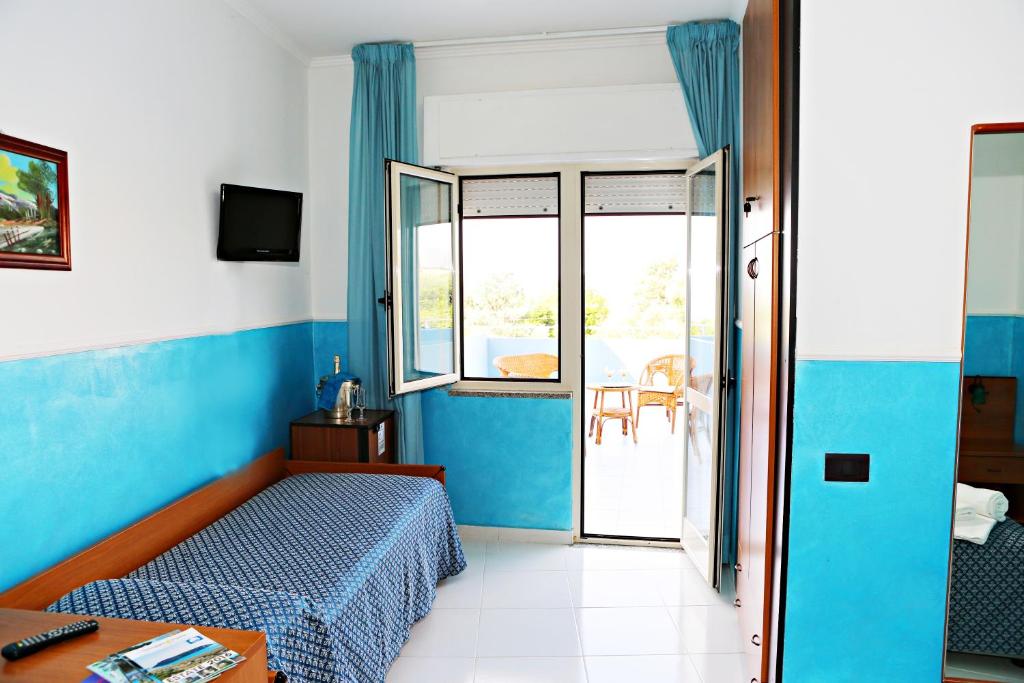 Postel nebo postele na pokoji v ubytování Hotel Blu Eden