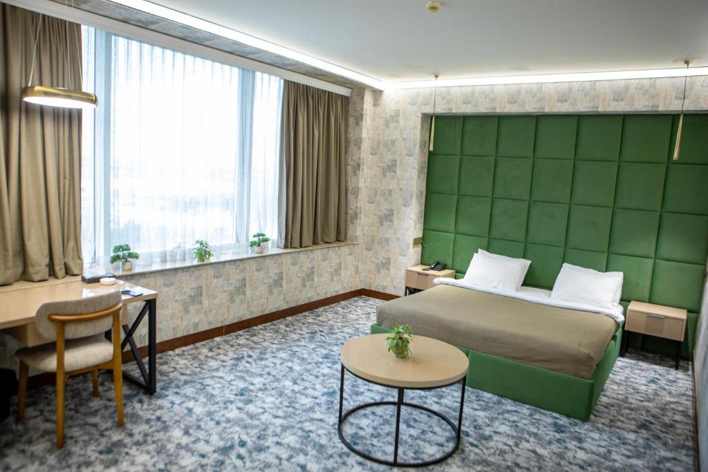 een hotelkamer met een bed en een bureau bij Innab Inn Hotel in Baku