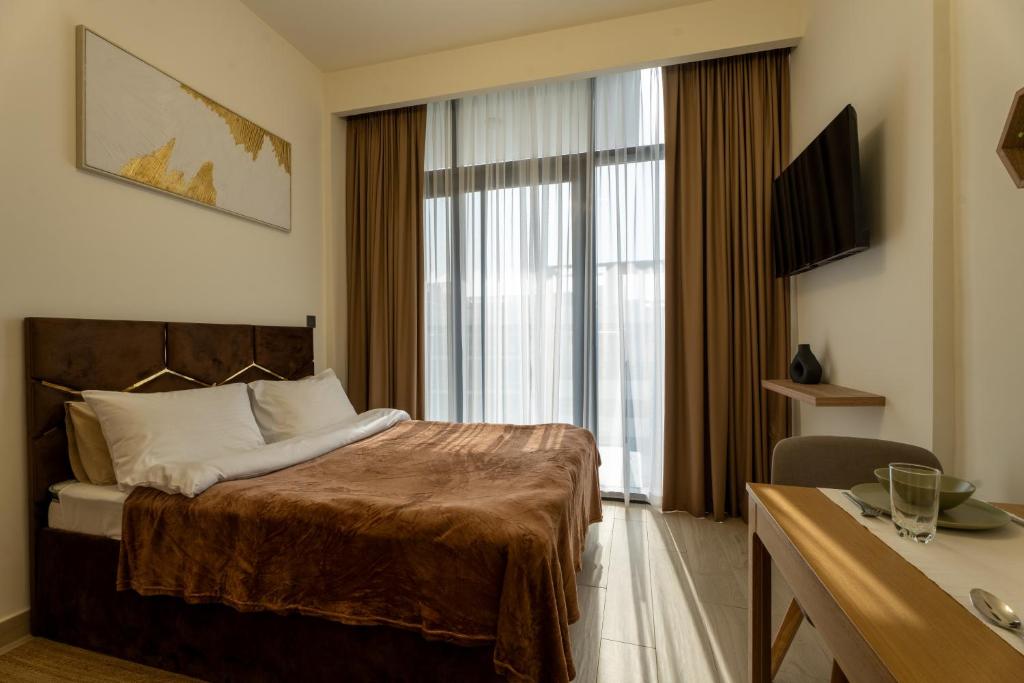 a hotel room with a bed and a window at Roomook Cozy studio in Dubai