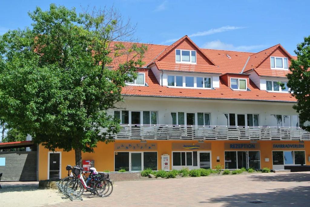 ein Gebäude mit davor geparkten Fahrrädern in der Unterkunft Bernsteinsee Hotel&Ferien in Sassenburg