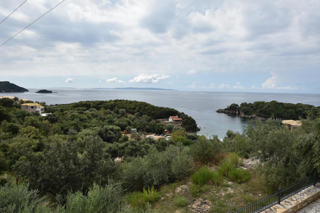 an island in the middle of a body of water at Sivota Apartments in Syvota