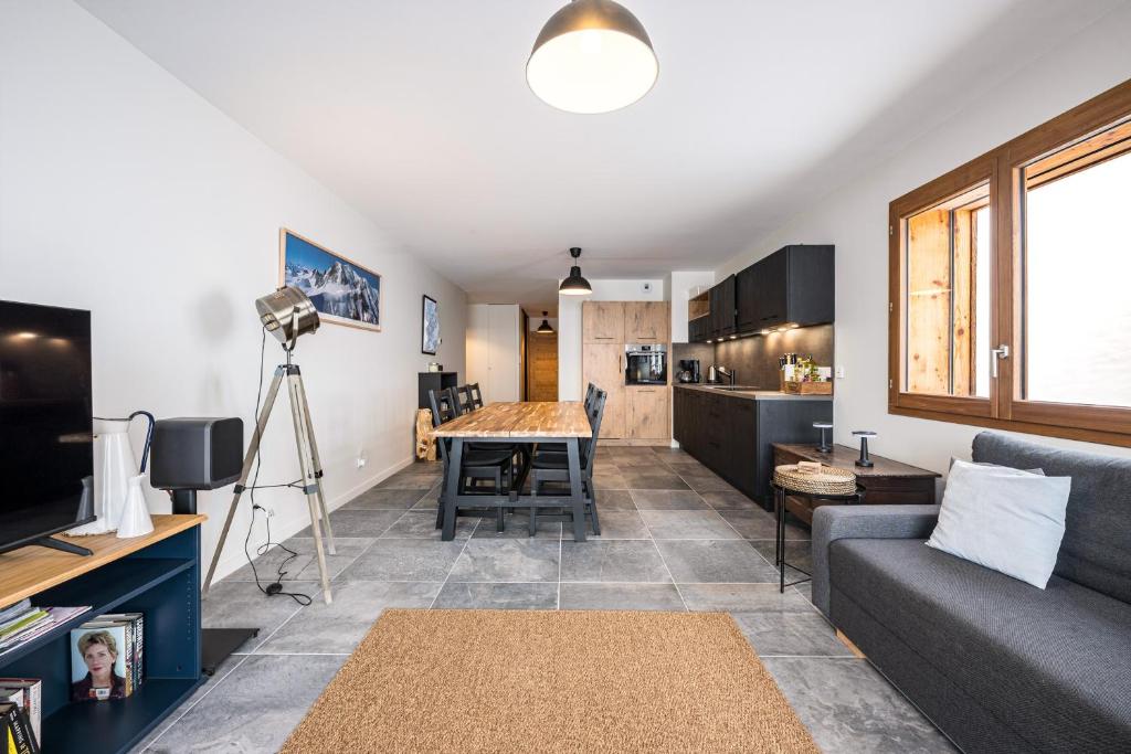 a living room with a couch and a table at Chalet Angelus C201 in Saint-Jean-de-Sixt