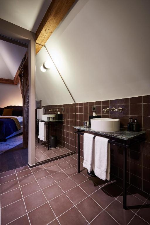 a bathroom with a sink and a large mirror at Boutique Hotel Spedition a member of DESIGN HOTELS in Thun