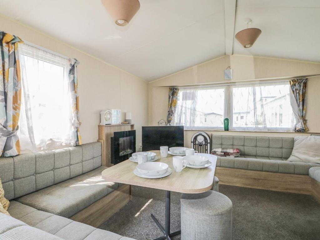 a living room with a couch and a table at Tower View Number 34 in Pevensey