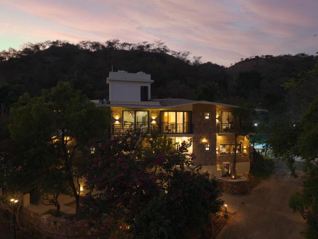 a large building with lights in the night at SaffronStays Grand Pavilion in Udaipur