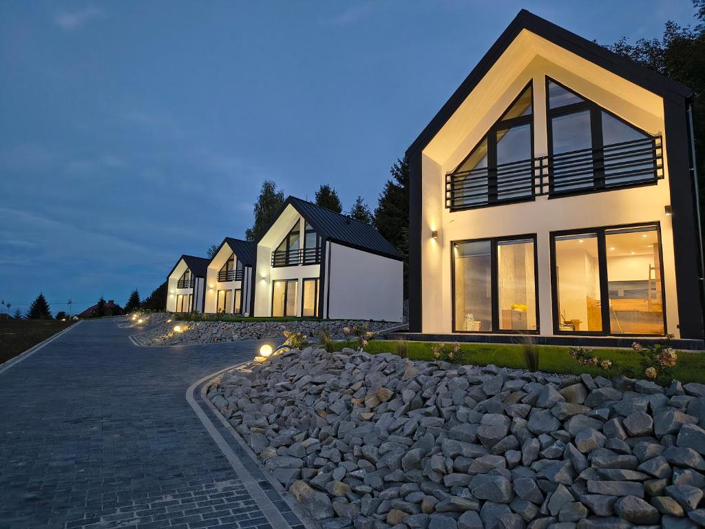 a row of houses on a road with rocks at Domki nad jeziorem in Dobczyce