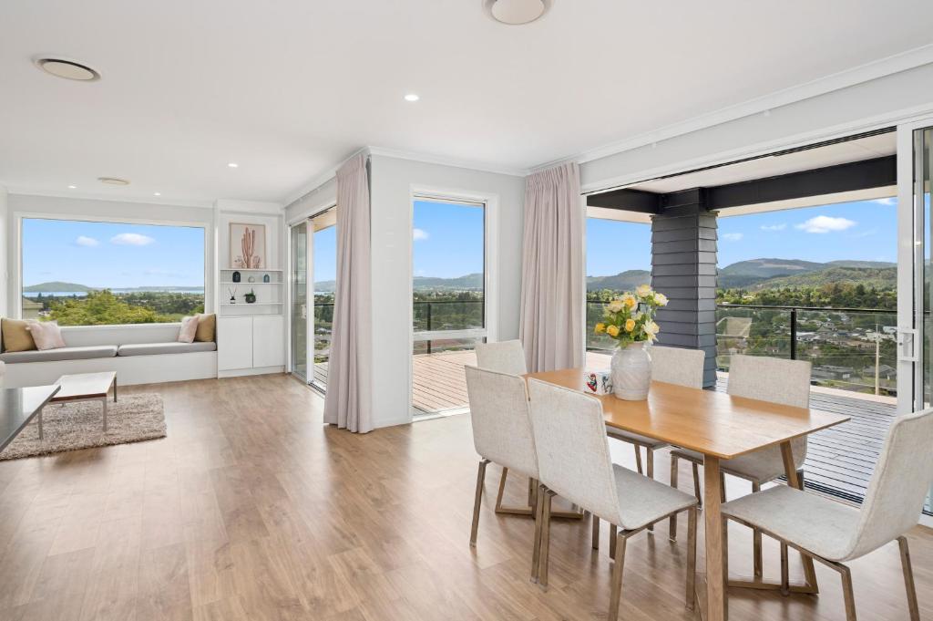 a dining room with a table and chairs at A million city views in Rotorua