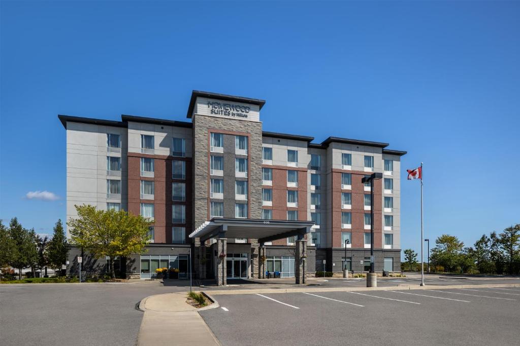 a building with a parking lot in front of it at Homewood Suites by Hilton Toronto-Ajax in Ajax