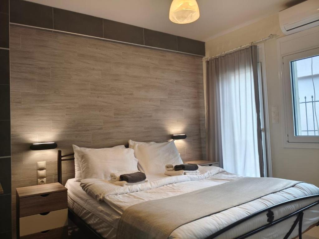 a bedroom with a large bed with a wooden wall at peramalux in Ioannina
