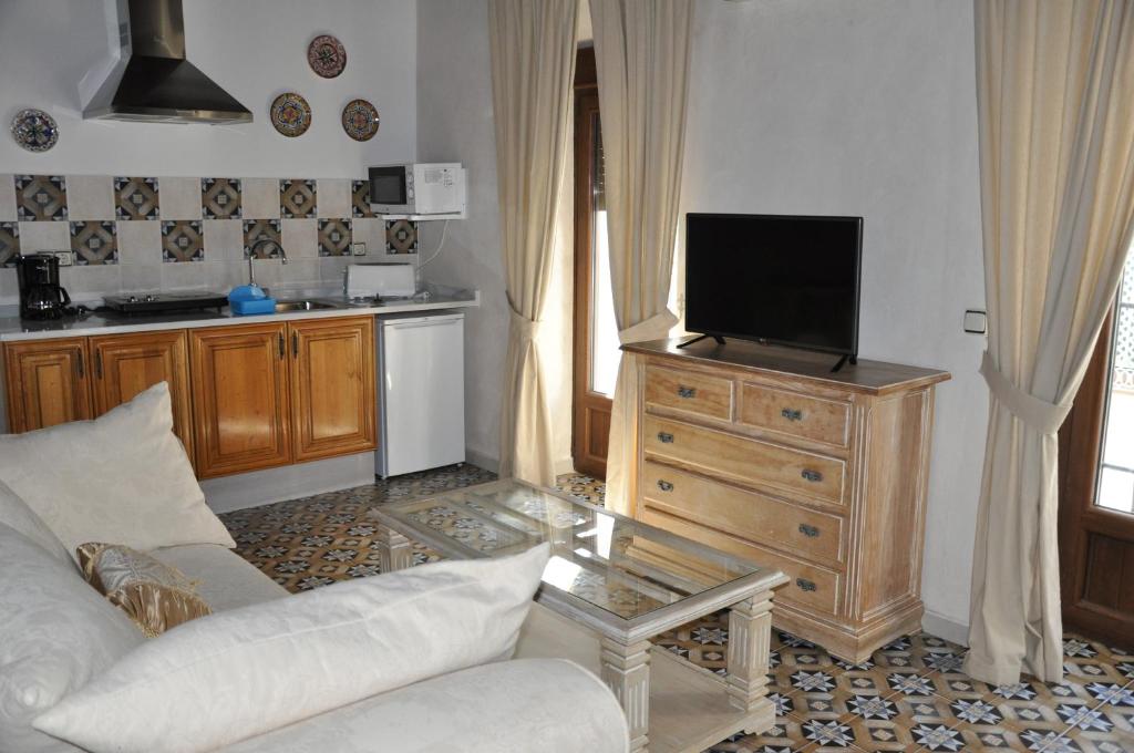 a living room with a couch and a tv on a dresser at Casa de las Remigias in Estepona