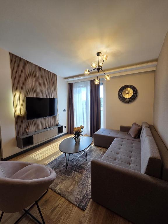 a living room with a couch and a tv at Dukk in Belgrade