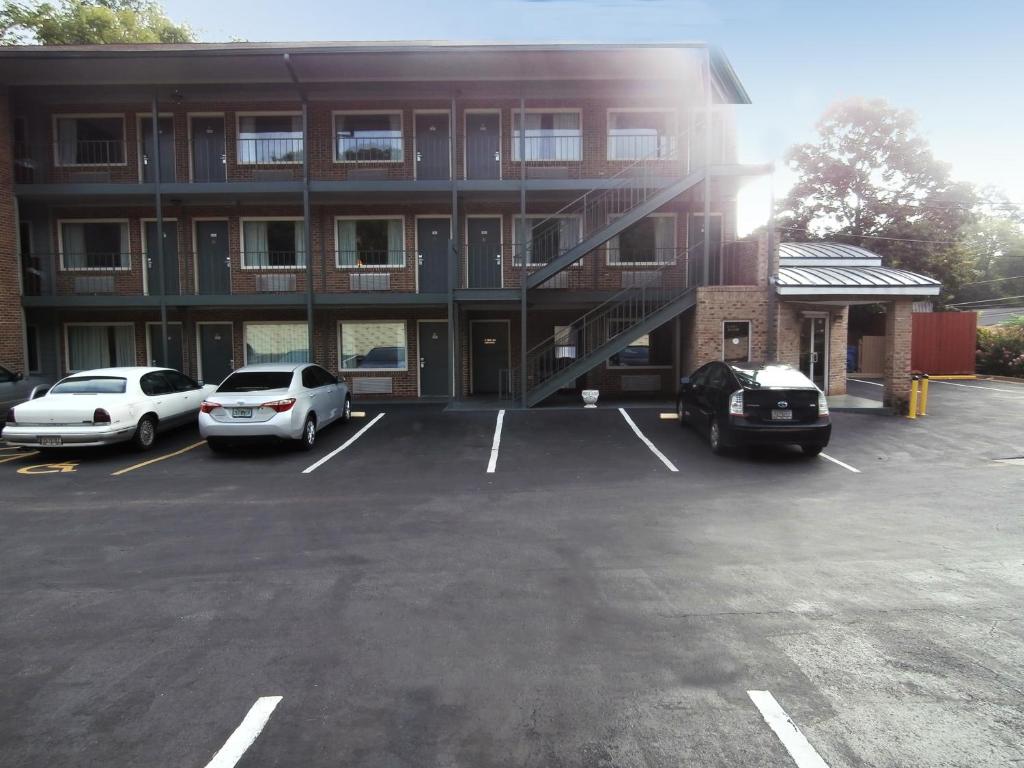 a parking lot in front of a building with cars parked at Americas Best Value Inn Athens in Athens