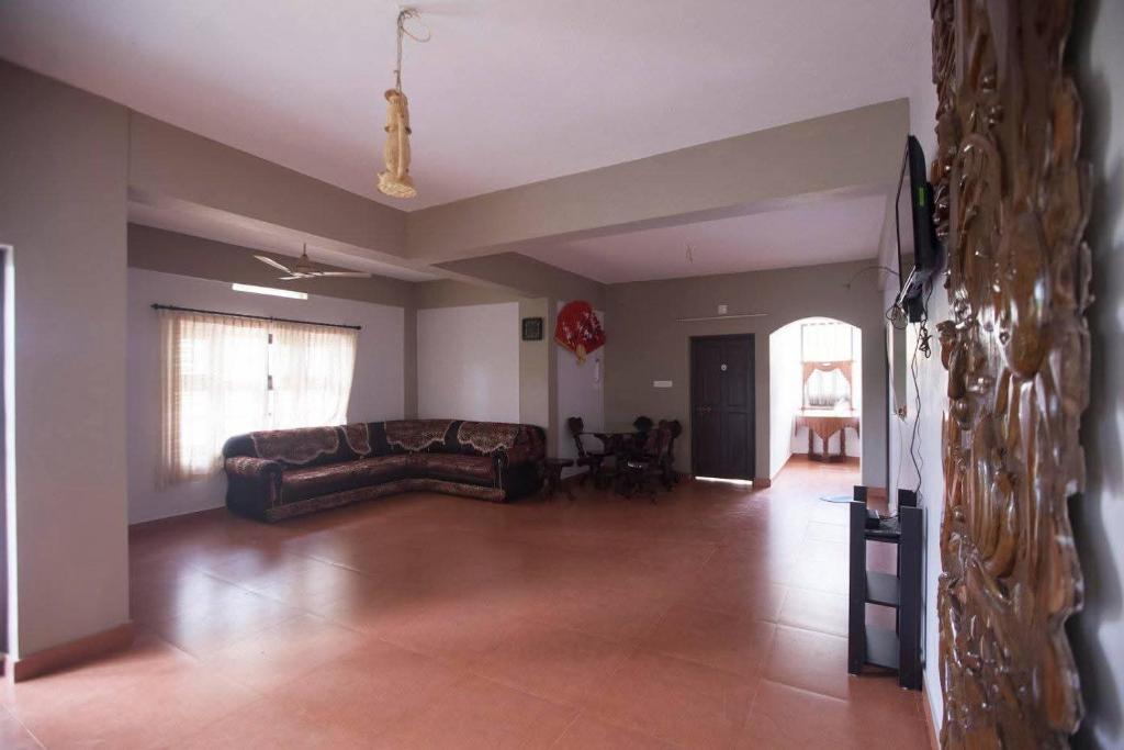 a living room with a couch and a table at Tapovan Fruitopia in Sultan Bathery