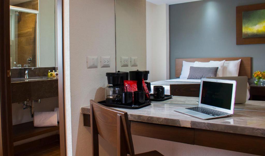 Postel nebo postele na pokoji v ubytování Eco Hotel Guadalajara Expo